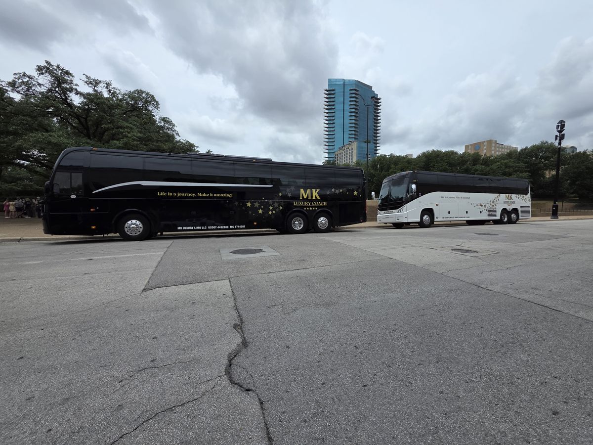 MK Luxury Coach fleet with Dallas skyline in the background
