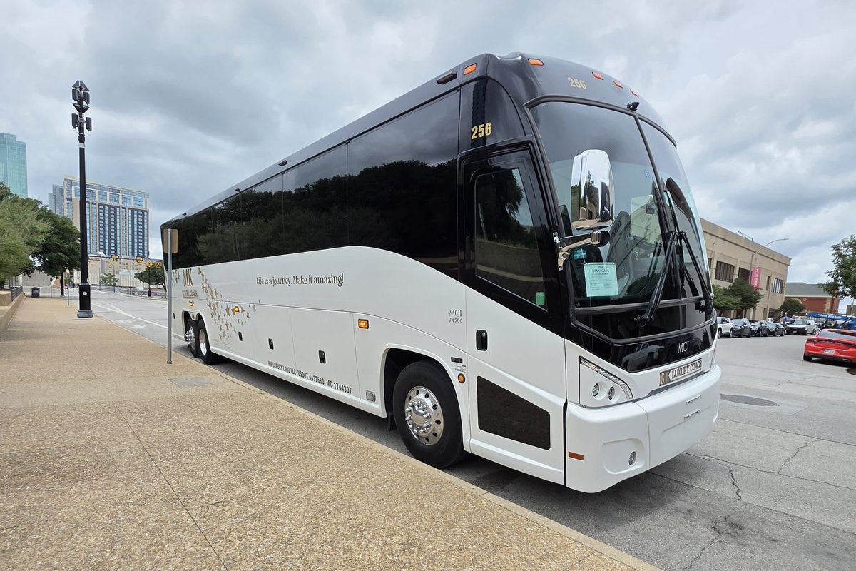 MK Luxury Coach white luxury motor coach at a Dallas wedding venue